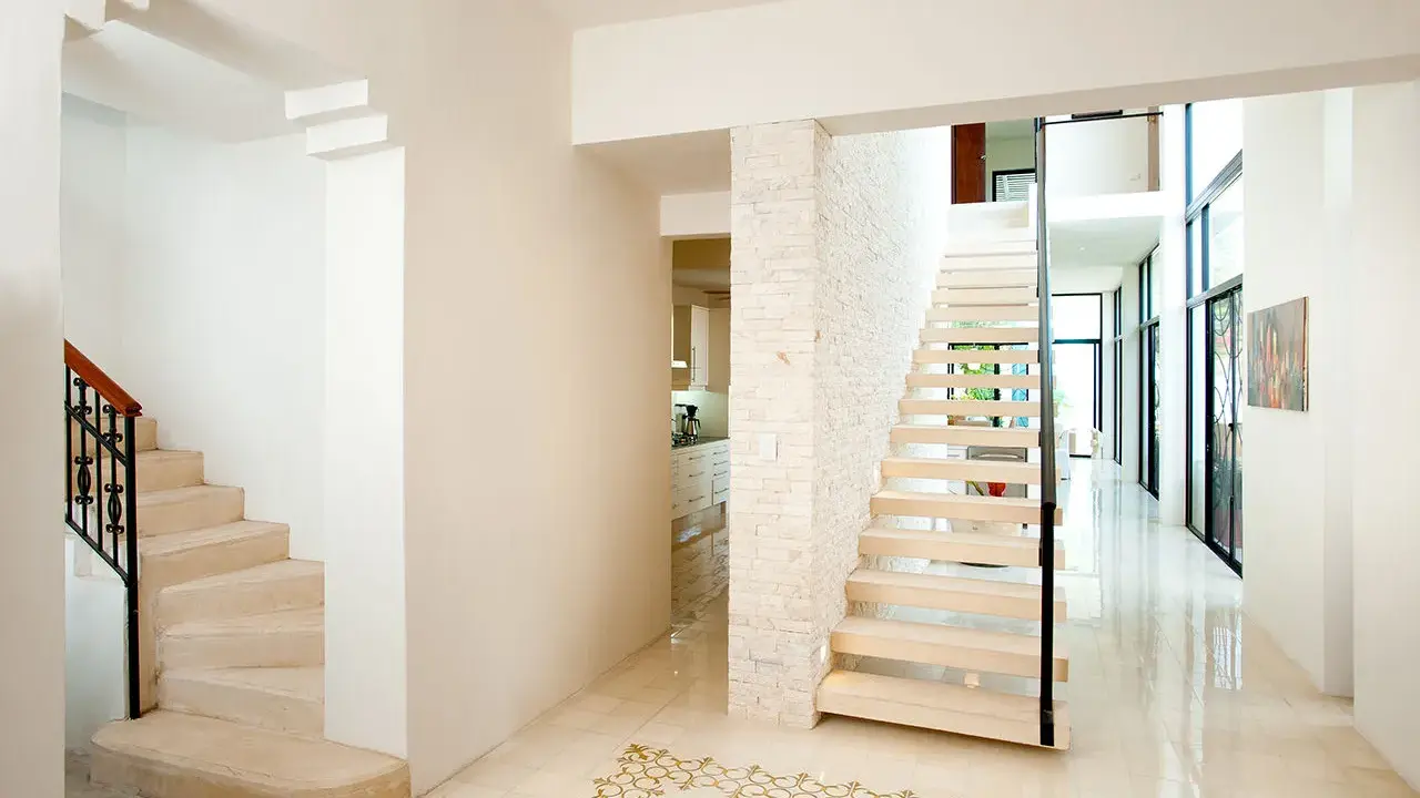 Pasillos con encanto, con escaleras de diseño moderno y clásico, y un suelo de baldosas con motivos dorados.