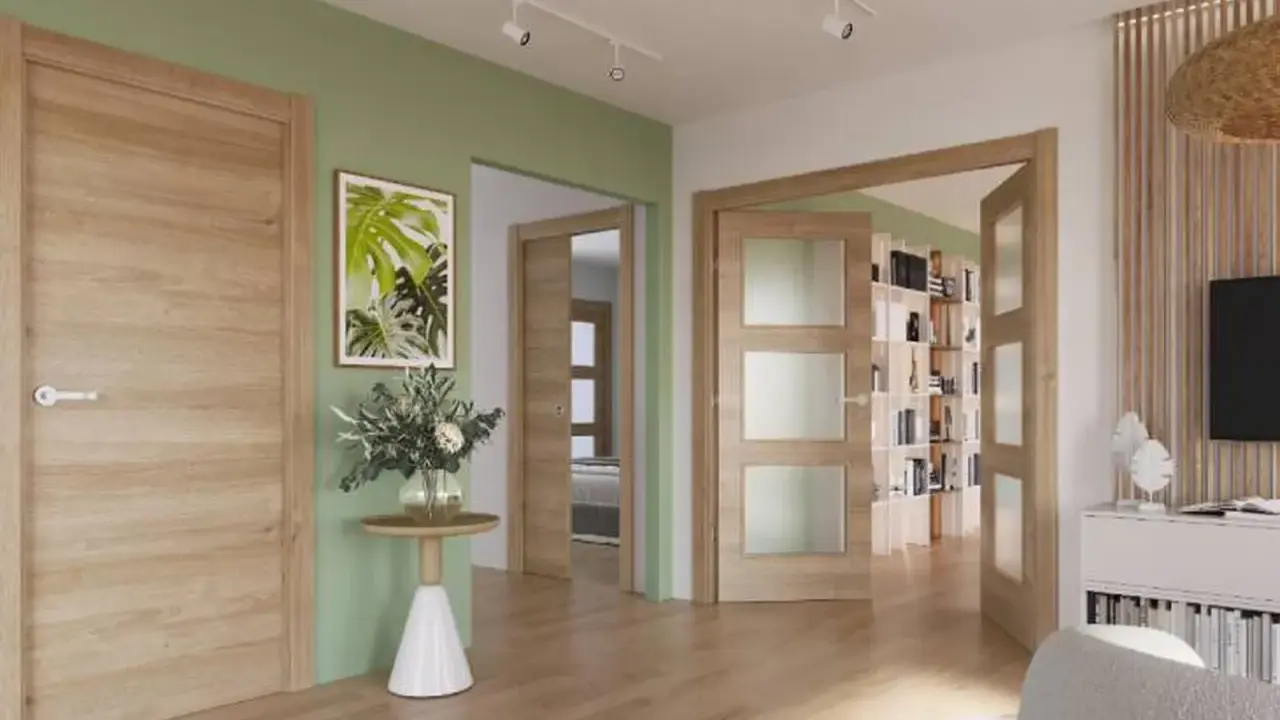 Puertas de roble con paneles de cristal, combinan con paredes verdes y suelo de madera.