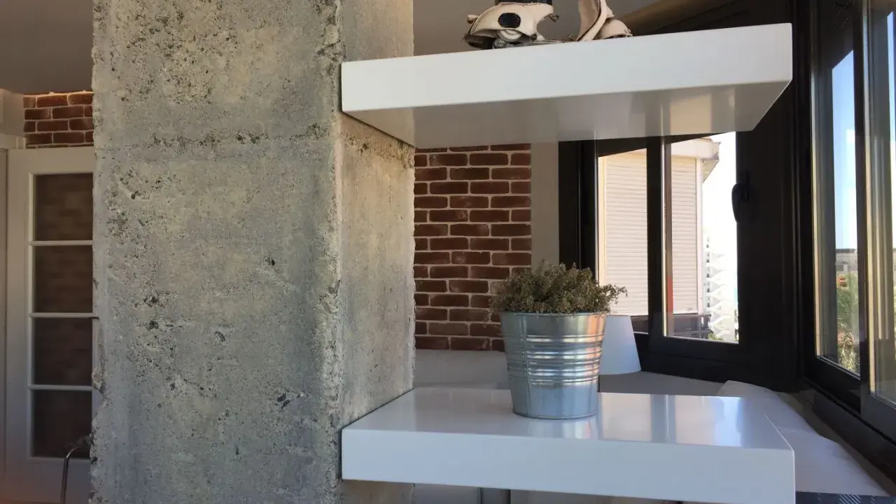 Ideas para decorar una columna en el salón: estantes blancos con Vespa y planta, ladrillo visto y hormigón.