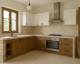 Cocina de obra con encimera de hormigón, muebles de madera y ladrillo visto. Ventana con grifo y campana extractora sobre la vitrocerámica.