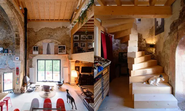 Estudio de diseño interior con escaleras de madera, perros y mobiliario ecléctico.