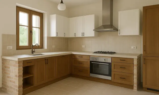 Cocina de obra con encimera de hormigón, muebles de madera y ladrillo visto. Ventana con grifo y campana extractora sobre la vitrocerámica.