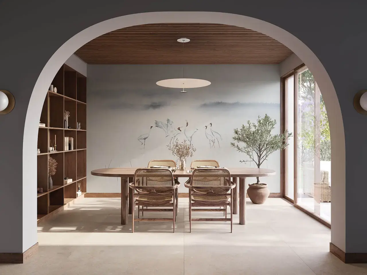 Comedor con mural de grullas, estantería de madera y mesa ovalada. Un espacio que evoca la armonía del feng shui.