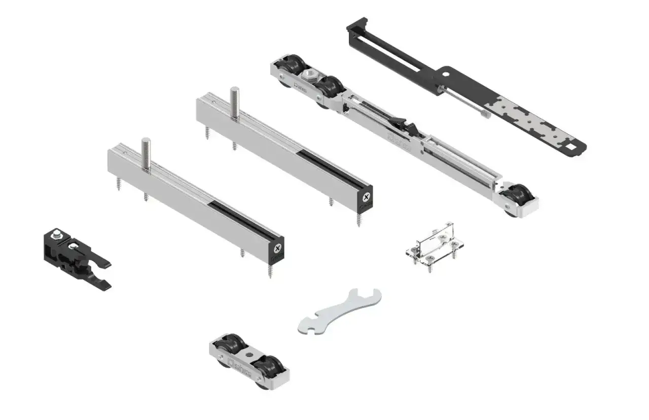 Componentes de puerta corredera: rieles, ruedas, soportes y llave inglesa.